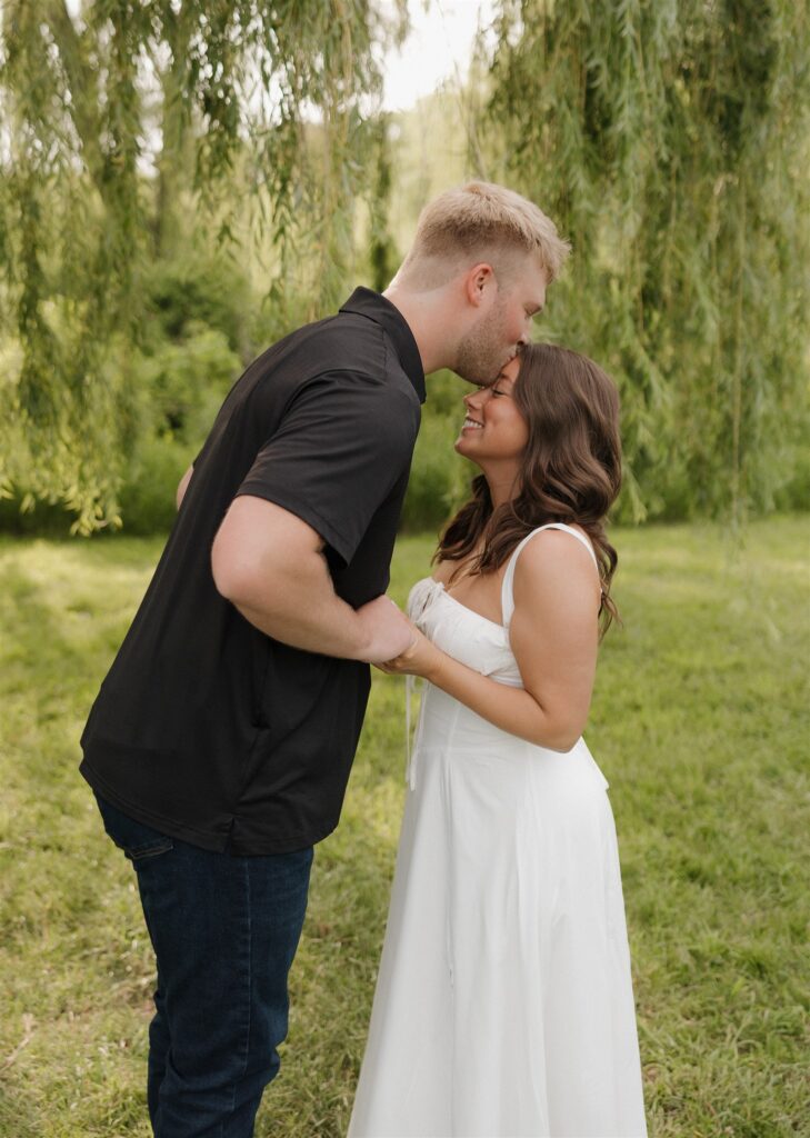 fiance kissing his fiance on the forehead 