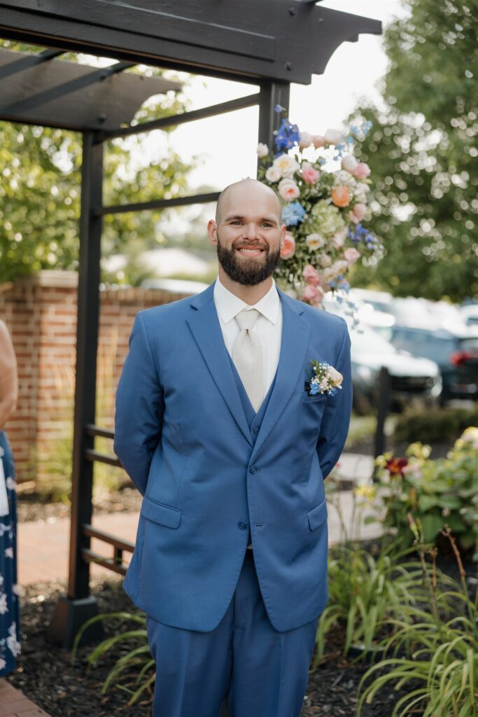 picture of the groom watching the bride walk down the aisle