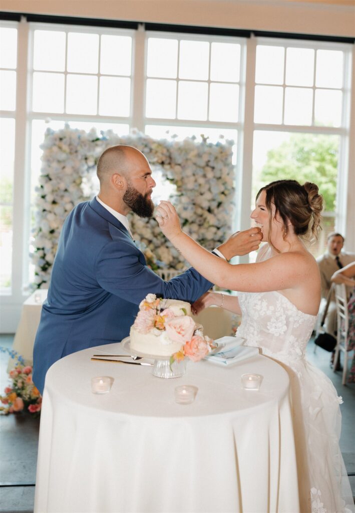 cute picture of the newly married couple trying their wedding cake