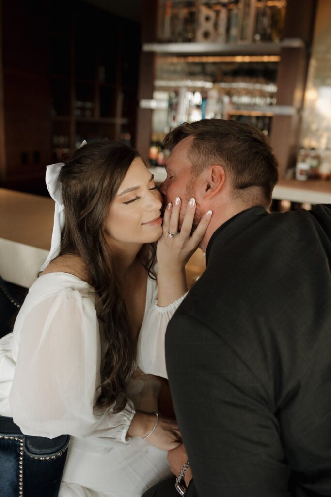 fiance kissing his fiance on the cheek