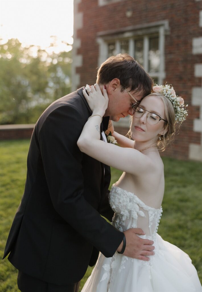 Groom, kissing the bride on the forehead