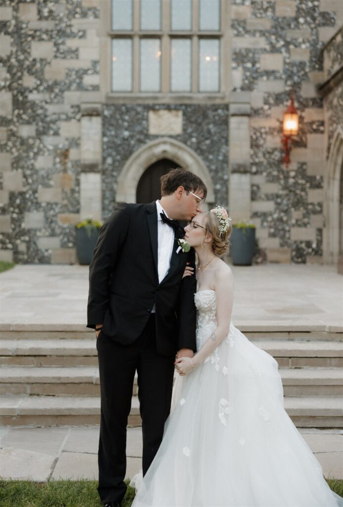 Cute picture of the groom, kissing the bride on the forehead
