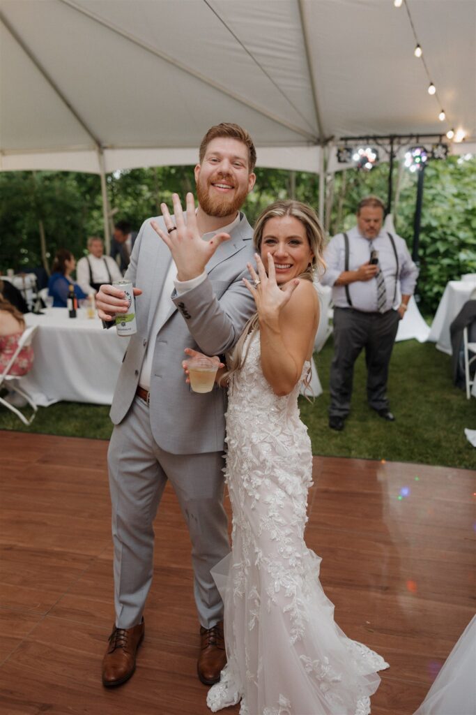 picture of the bride and groom showing their wedding rings