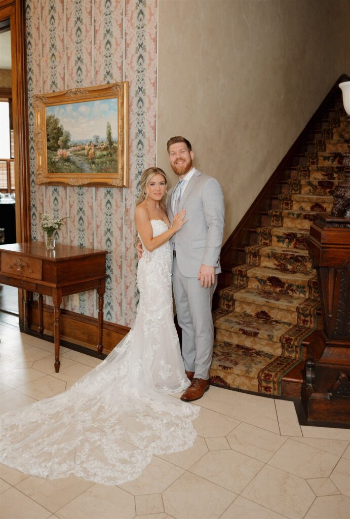Couple smiling at the camera during their bridal portraits