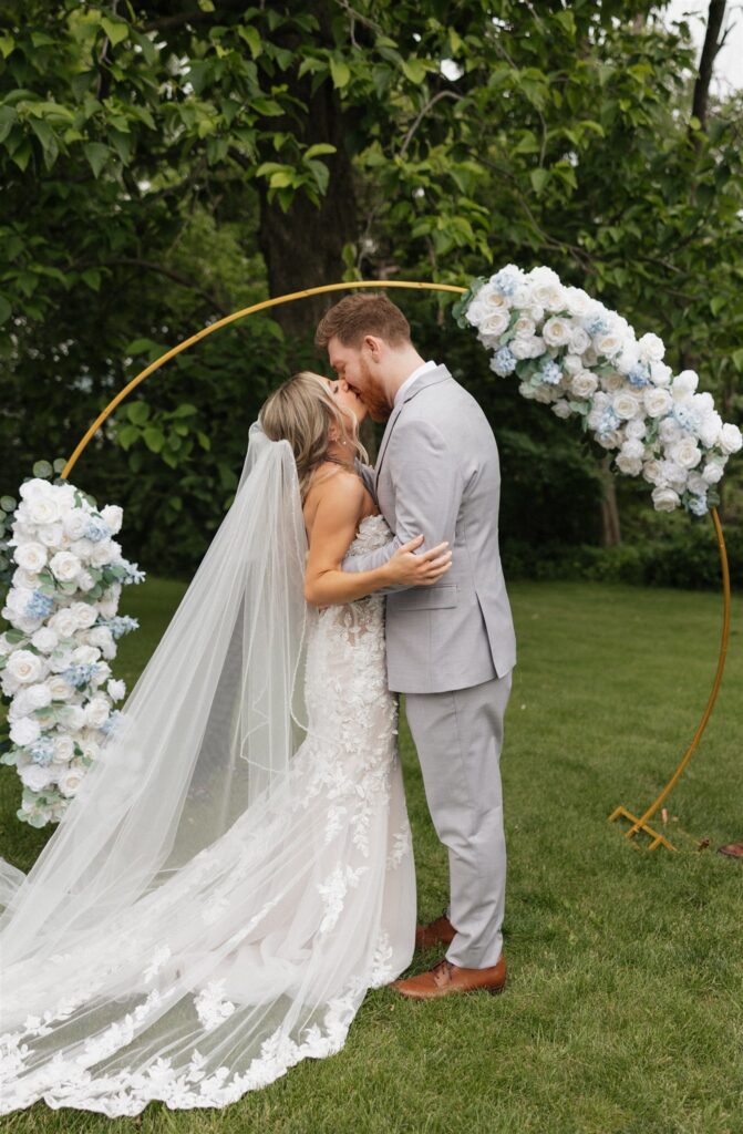 cute picture of the bride and groom kissing after their ceremony
