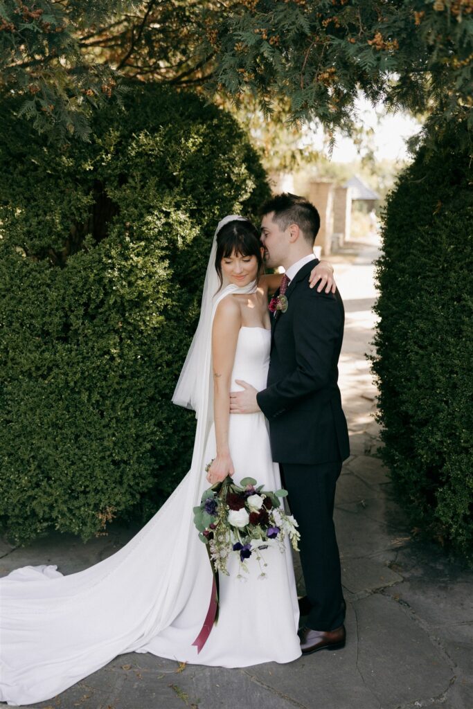 groom kissing the bride in the forehead