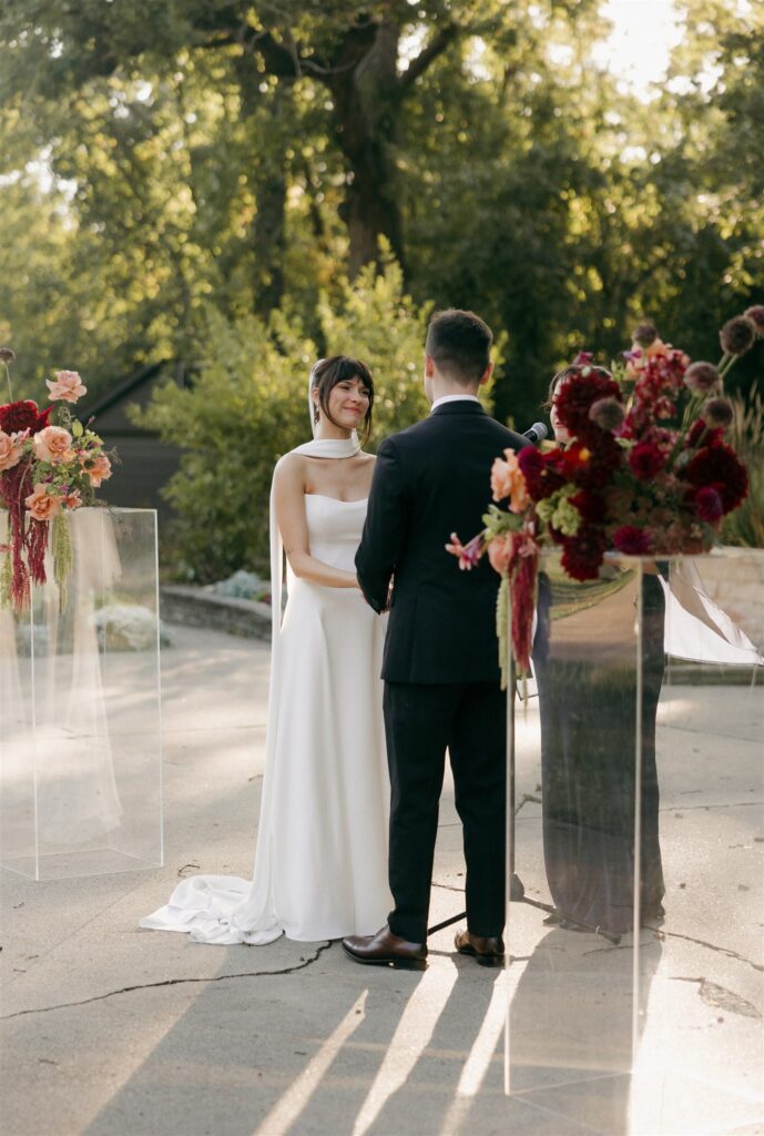 bride and groom holding hands during their wedding ceremony