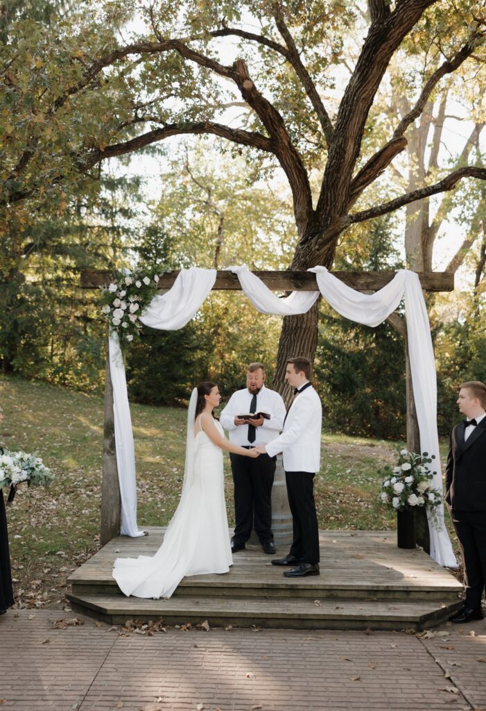bride and groom holding hands during their ceremony