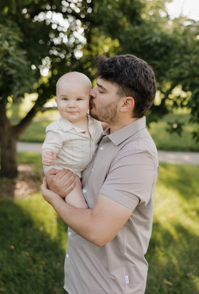 dad kissing his son on the cheek during their family session