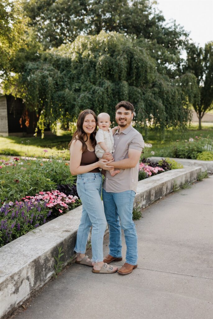 family smiling at the camera during their photoshoot