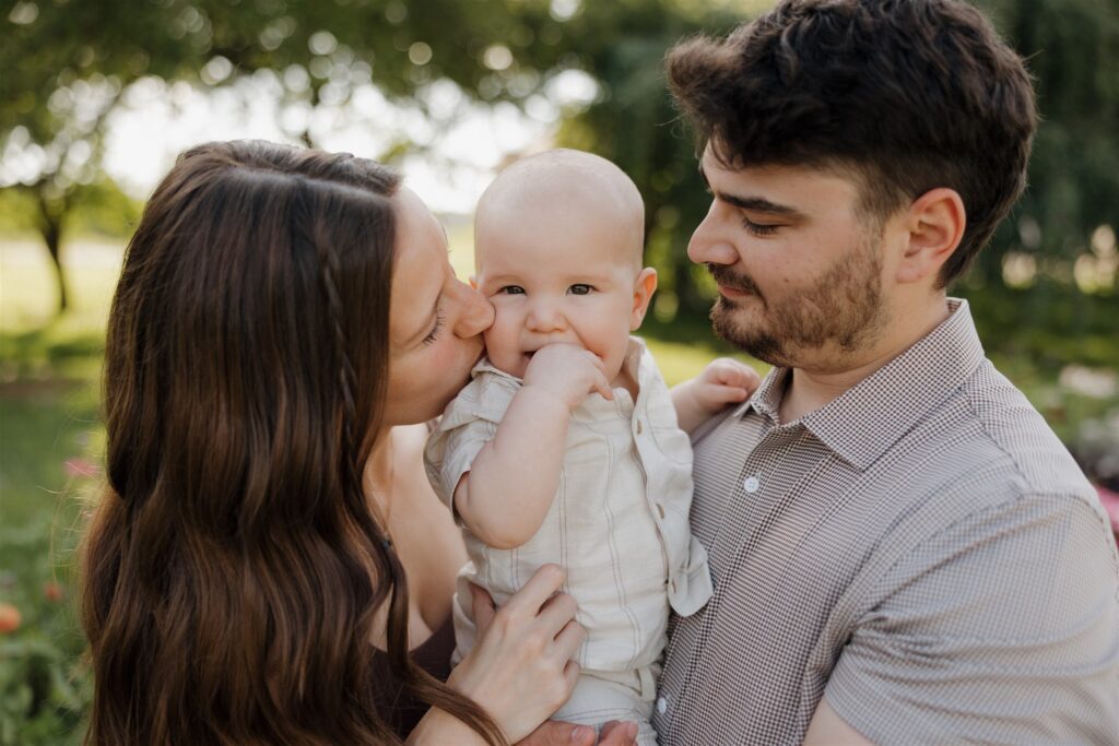 mom kissing her son on the cheek during their family session
