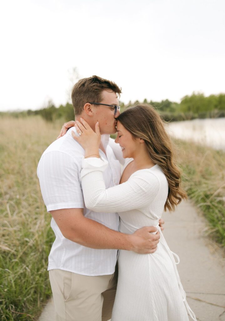 fiance kissing his fiance on the forehead