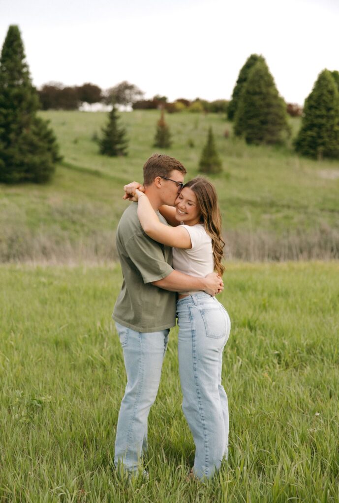 fiance kissing his fiance on the cheek