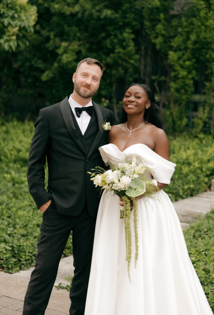 newlyweds smiling at the camera during their photoshoot