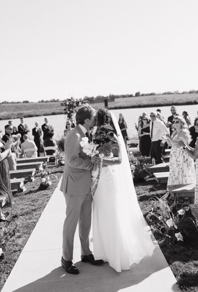 cute picture of the newlyweds kissing after the ceremony
