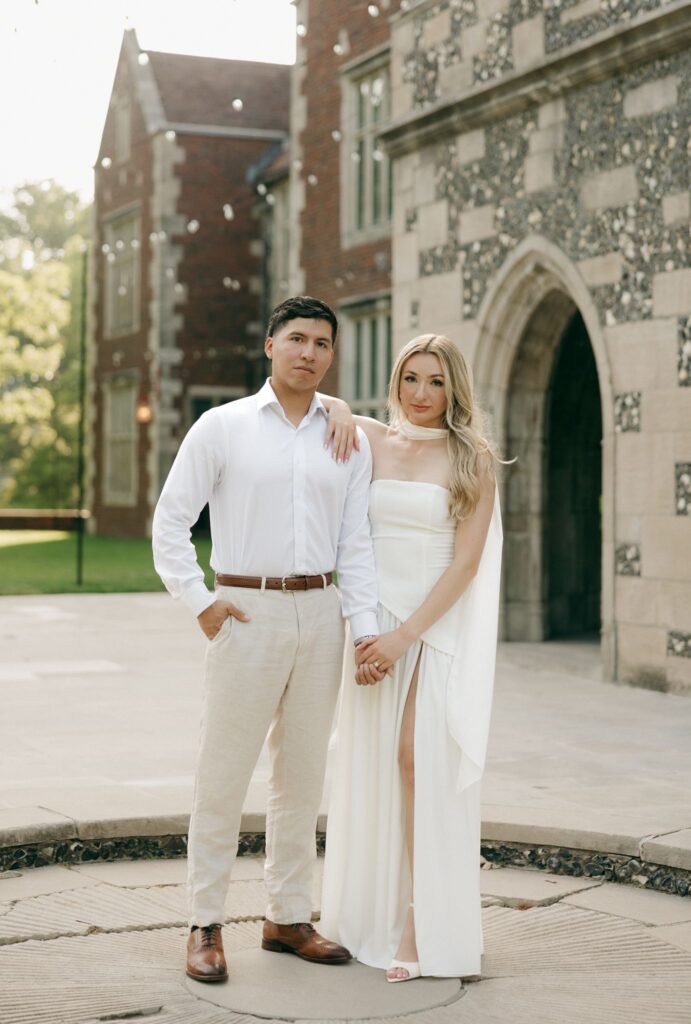 newly engaged couple smiling at the camera during their photoshoot
