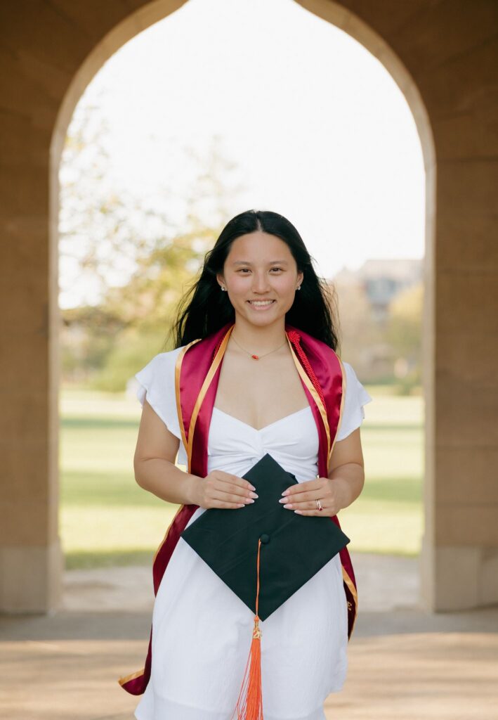 grad smiling at the camera during her photoshoot