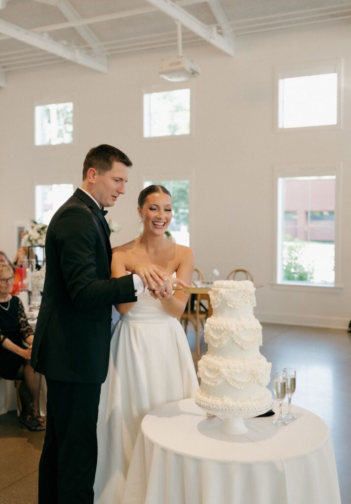 newlyweds cutting their wedding cake